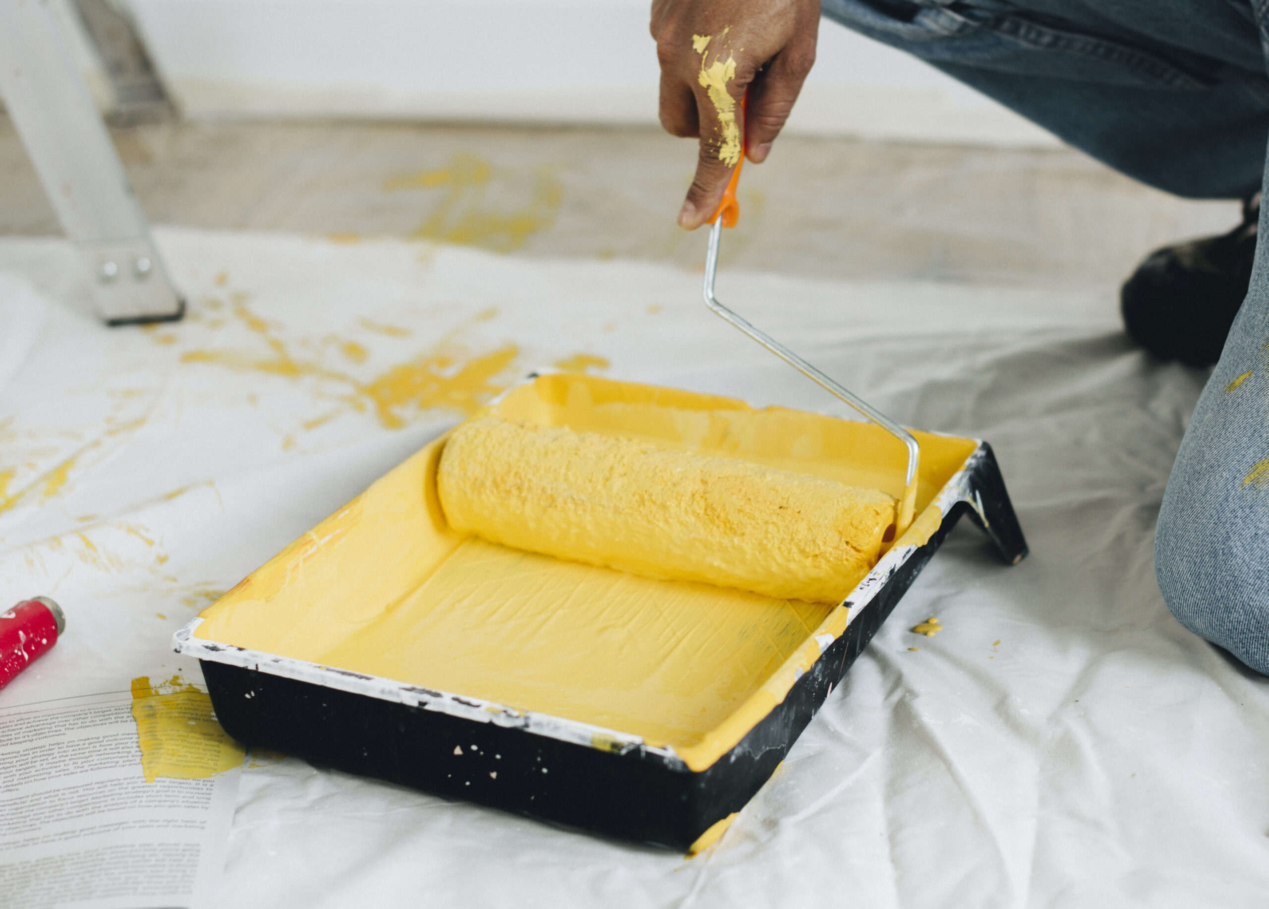 Man painting the walls yellow